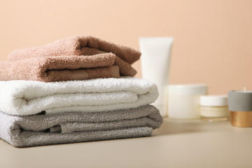 a stack of fresh towels on the table.