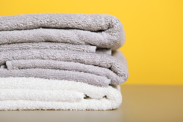 Obraz na płótnie Canvas a stack of fresh towels on the table.