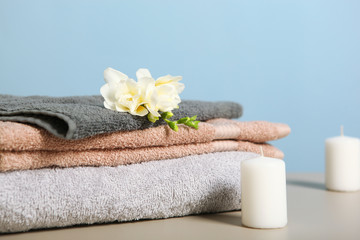 a stack of fresh towels on the table.