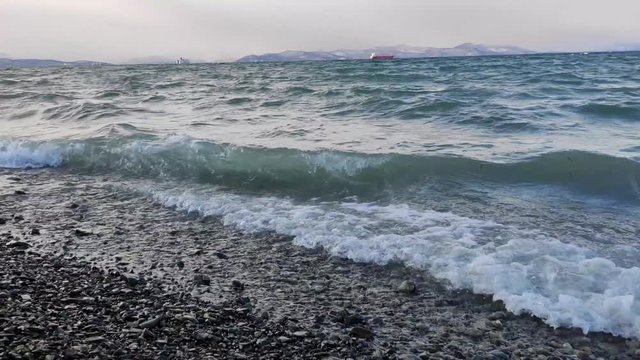 Ocean waves crash into rocky beach
