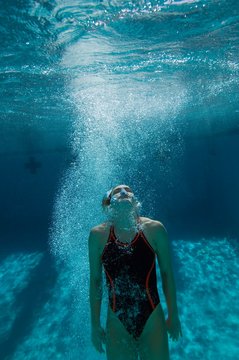 Female Diver Coming Up For Air After Dive