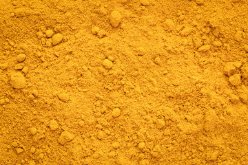 Turmeric root powder background and texture