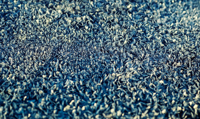 natural background with texture shiny transparent crystals of cold frost cover the surface in winter frosty morning
