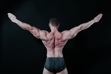 the athlete bodybuilder shows his muscles after sports