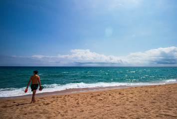 Caucasian boy playing on the beach