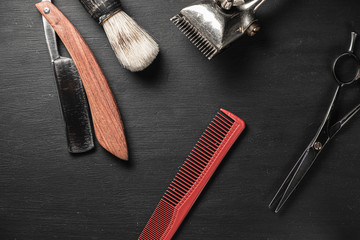 vintage barber tools dangerous razor hairdressing scissors old manual clipper comb shaving brush. old black background.