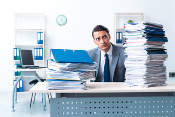 Businessman with heavy paperwork workload