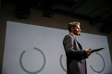 Attractive and confident successful man with headset speaking at corporate business coaching and training conference.Business and Entrepreneurship event,motivation training