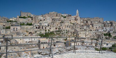 Fototapeta na wymiar Matera is a city located on a rocky outcrop in Basilicata, in Southern Italy. It includes the area of the Sassi, a complex of Cave Houses excavated in the mountain.