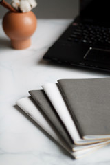 business background. notebooks white and grey. notebook in a cage on beautiful backgrounds. Close-up with blurred background.