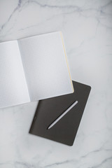 business background. notebooks white and grey. notebook in a cage on beautiful backgrounds. Close-up with blurred background.