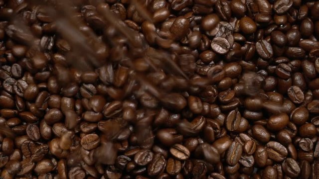 Closeup of roasted coffee beans poured.