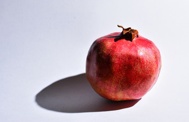 Single Pomegranate isolated with white background.