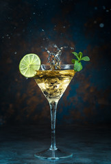 Mojito cocktail in martini glass on black background