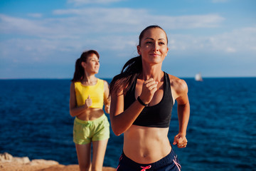 girls play sports jog on the beach