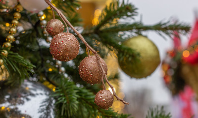 Christmas and New Year composition. Christmas tree branch decorated with Xmas lights,  balls, cones, snowflakes, baubles. Holiday background.