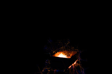 Burning sparks on exposure, black background