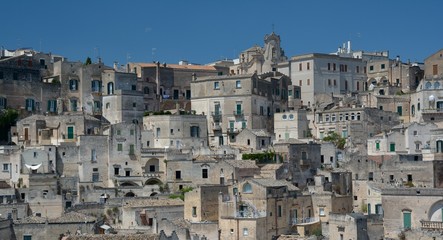 Fototapeta premium Matera is a city located on a rocky outcrop in Basilicata, in Southern Italy. It includes the area of the Sassi, a complex of Cave Houses excavated in the mountain.