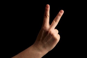 Numbers 2 in sign language. gesture number 2 with hand sign. women hand sign isolated on black background. finger pointer