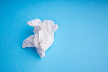  Crumpled paper napkins. White hygiene napkins on a blue background. Skincare mockup for design. Pile of disposable napkins. Cosmetology concept.