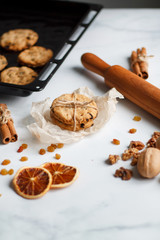 Christmas composition. cookies tied, rolling pin, cinnamon, cookies and dried orange, nuts, raisins. 