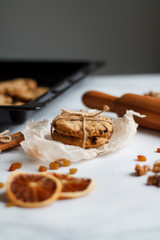 Christmas composition. cookies tied, rolling pin, cinnamon, cookies and dried orange, nuts, raisins. 