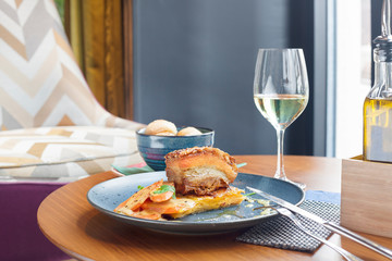 Roasted pork belly meat served with glass of white wine