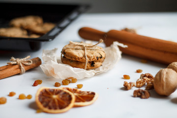 Christmas composition. cookies tied, rolling pin, cinnamon, cookies and dried orange, nuts, raisins. 