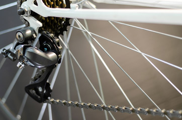 Fototapeta premium Grodno, Belarus, January 14, 2019: Bicycle repair. Installing a modern rear derailleur on a vintage road bike frame. Cassette and rear derailleur closeup on black background