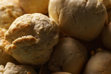 Homemade Italian mini garlic bread buns made of pizza dough balls, filled with herb butter as traditional side dish - close-up macro shot, horizontal format