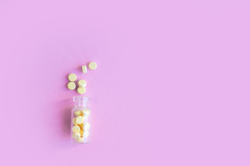 homeopathic globules and glass bottle on pink background. Alternative Homeopathy medicine herbs, healtcare and pills concept. Flatlay. Top view. copyspace for text.