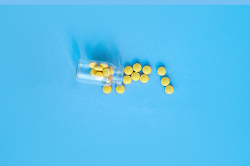 homeopathic globules and glass bottle on blue background. Alternative Homeopathy medicine herbs,...