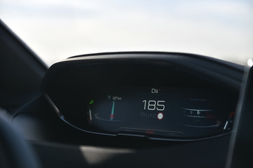 Closeup of a car dashboard. Speeding while driving.