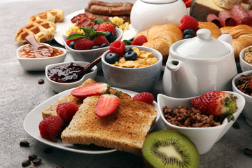 Breakfast served with coffee, orange juice, croissants, cereals and fruits. Balanced diet. 