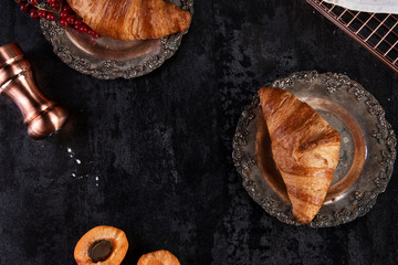 Croissants on the black table. Nice french breakfast - obrazy, fototapety, plakaty