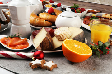 Breakfast served with coffee, orange juice, croissants, cereals and fruits. Balanced diet. Continental breakfast on christmas