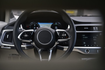 Fototapeta na wymiar Steering wheel and dashboard in a car