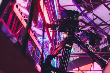 Professional equipment in a blue television news studio. Lighting devices and video cameras on a...