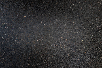 Smooth wet asphalt surface, top view of grunge rough road with black stone's glitter, textured...