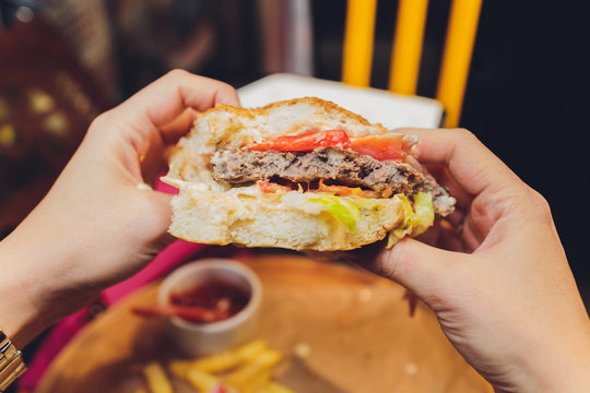 POV Woman Eating Hamburger Hand Holding Half Eaten Hamburger