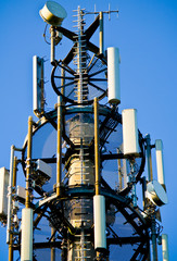 Fototapeta na wymiar Detail of a 3G, 4G LTE transmitter tower against clear blue sky