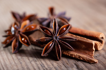 cinnamon and star anise sticks lie on an old wooden background close-up