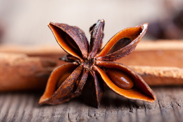 cinnamon and star anise sticks lie on an old wooden background close-up
