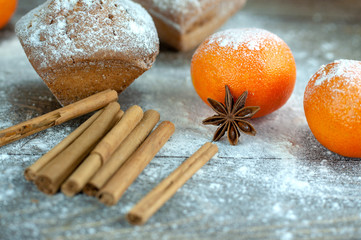 delicious fresh muffins with flour on a wooden table