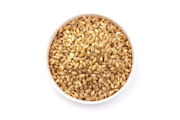Bowl of pearl barley, isolated on white background