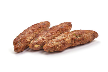 Fried cevapcici, balkan sausages, isolated on white background