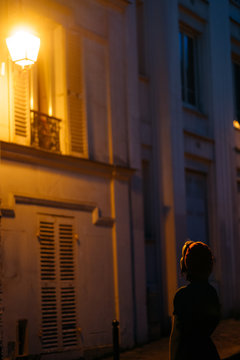 young woman waiting in a portal of Paris