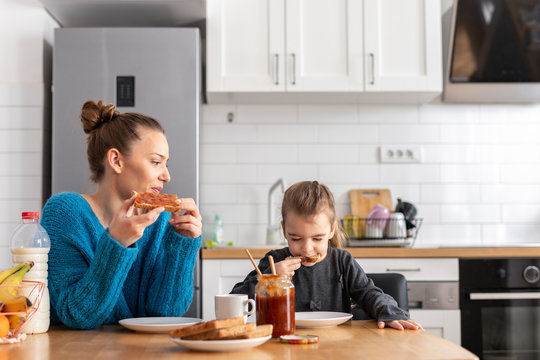 Mother and daughter having breakfast