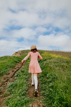 Girl running up hill