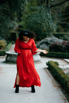 disability woman in red enjoying the music with headphones